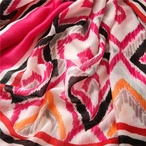 Detailed texture of bohemian ikat geometric patterns on colorful cotton linen shawl scarf