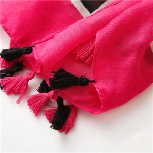 Detailed macro view of pink cotton linen shawl with black and pink fringe tassels