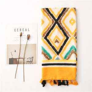 Detailed macro view of bohemian geometric pattern scarf with soft cotton tassels