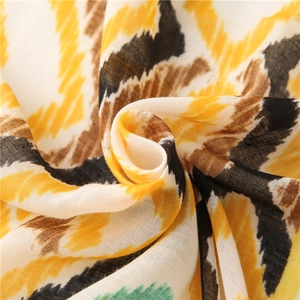 Detailed macro view of bohemian scarf fabric with yellow and black geometric patterns