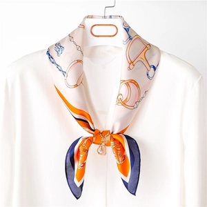 Retro silk scarf with equestrian chain print worn on a white shirt collar