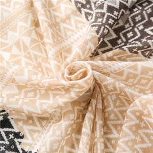 Detailed close-up showing the soft woven cotton texture and tribal geometric scarf patterns