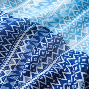 Macro shot of blue geometric diamond pattern and soft fabric texture on cotton linen shawl