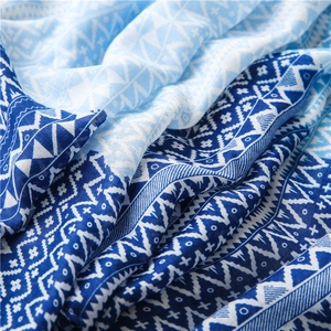 Detail of blue geometric star pattern on lightweight cotton linen scarf fabric texture