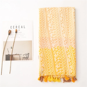 Close-up of bohemian geometric scarf with handmade tassels and woven linen texture