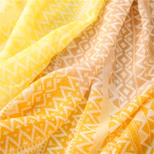 Close-up of yellow geometric pattern scarf showing textured cotton linen fabric details