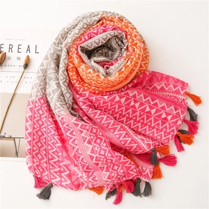 Detail of multi-color bohemian cotton linen scarf with geometric patterns and fringe tassels