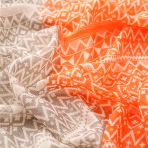 Detailed view of the orange and gray geometric pattern on cotton linen scarf fabric