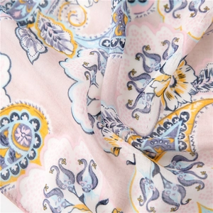 Macro shot of pink and blue paisley printed fabric with soft cotton-linen texture