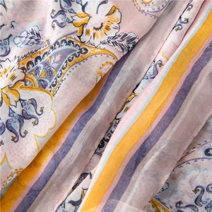 Close-up of paisley print and colorful stripes on soft semi-transparent summer scarf
