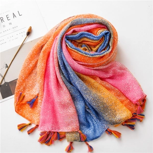 Detail of gradient cotton linen scarf with colorful tassels and snowflake texture