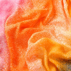 Detail of orange and pink gradient shawl with fine speckled texture and soft drapes