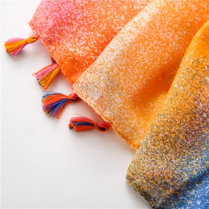 Detail of gradient cotton linen scarf with colorful spray print and fringe tassel