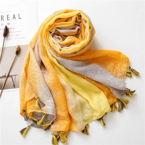 Lightweight gradient yellow and grey linen-feel scarf with star pattern and tassels
