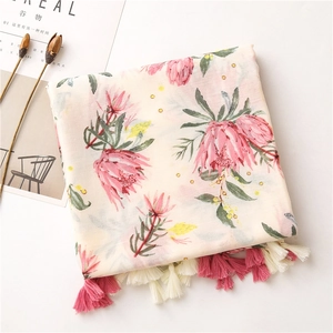 Detailed view of floral cotton linen scarf with pink protea prints and fringe edges