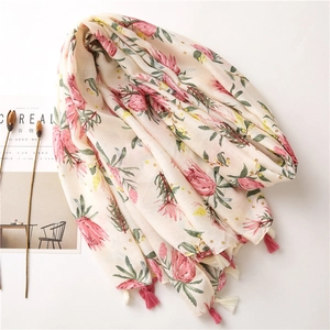 Floral cotton linen scarf with pink flower prints and tassel details on white background