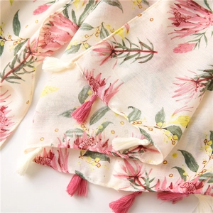 Detailed macro of vintage floral cotton-linen scarf with dual-tone fringe tassels