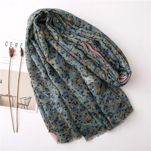 Floral cotton linen scarf in dark green with pink lining and tassel edges on white background