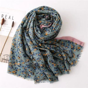 Floral cotton linen scarf in grey-blue and pink with frayed edges on white backdrop