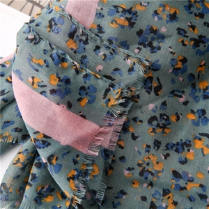 Close-up of lightweight floral linen scarf showing detailed weave and frayed edges