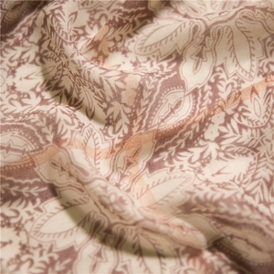 Gros plan d'un foulard bohème à motif paisley avec fils dorés et texture de tissu souple
