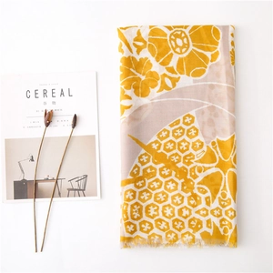Detail of floral print scarf with soft tassels and yellow honeycomb geometric pattern