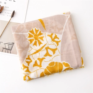 Close-up of lightweight linen texture scarf with yellow floral print and fringe detail