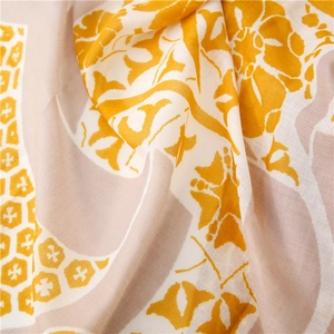 Macro detail of floral print cotton-linen scarf fabric with geometric texture and soft folds