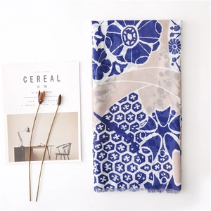 Flat lay of vintage floral printed cotton linen shawl with rustic decorative props