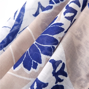 Detailed macro shot of vintage plant pattern print on soft cotton linen fabric texture