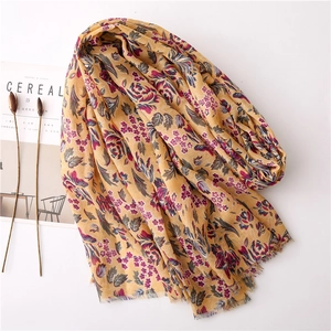 Floral cotton linen scarf in ginger yellow with tassel edges and breathable texture