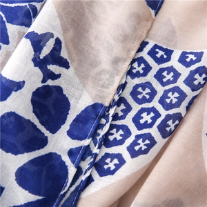 Close-up of lightweight linen cotton scarf with blue geometric print and stitched hem