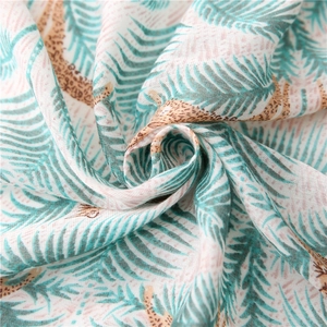 Tropical palm leaf and leopard print cotton linen scarf with soft draped texture