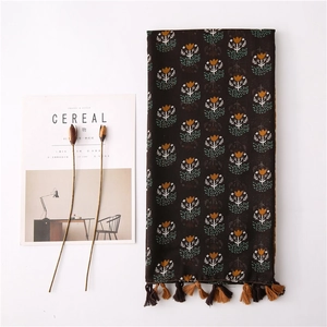 Bohemian linen scarf with brown floral patterns and tassel fringe detail