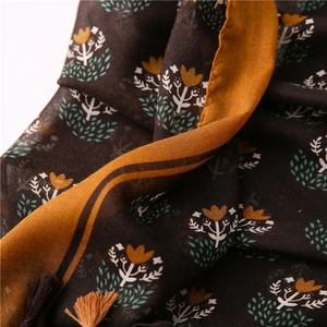 Detailed view of the vintage floral linen scarf with tulip prints and tassel edges