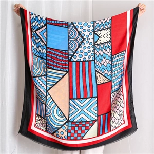 Detailed view of abstract geometric scarf featuring colorful patterns and tassel edges
