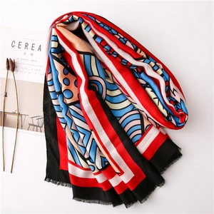 Abstract geometric art scarf with blue and red patterns and fringe details for women