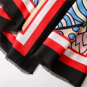 Close-up of colorful abstract geometric scarf with soft frayed edges and silky texture