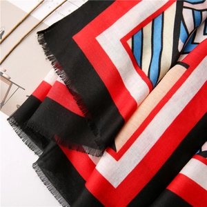 Detailed close-up of geometric color block scarf with soft cotton-linen fringe edges