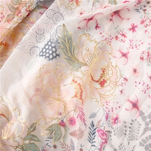 Close-up of soft floral scarf featuring gold foil outlines and delicate petal textures