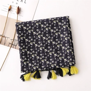 Close-up of navy floral cotton linen scarf featuring bicolor tassels and fine texture