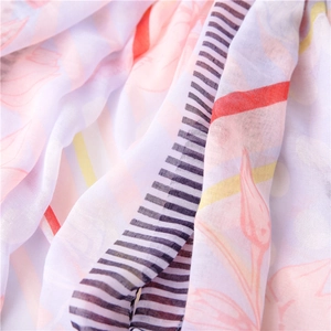 Close-up of lightweight beach shawl featuring floral prints and fine striped texture
