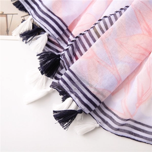 Detailed close-up of navy blue fringe tassels and floral cotton linen shawl fabric