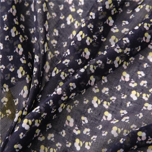Close-up of vintage floral printed fabric with breathable cotton linen texture in navy blue