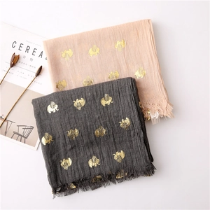 Detail of cotton linen scarf with gold foil elephant prints and delicate fringe edges