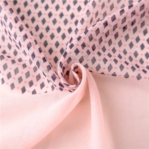 Lightweight pink scarf with black geometric diamond patterns and tassels for sun protection