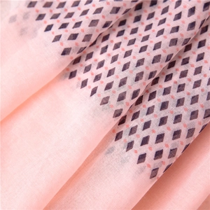 Detail of pink geometric diamond pattern on lightweight breathable summer scarf fabric