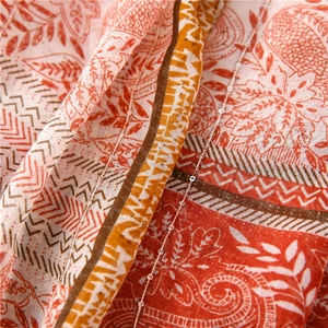 Macro shot of paisley pattern on cotton linen scarf with small shimmering sequins
