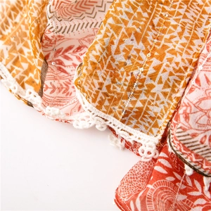 Detailed view of paisley cotton linen scarf with lace trim and shimmering sequins