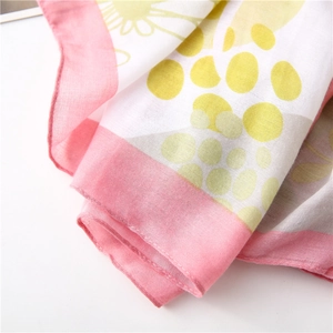 Detail of floral linen cotton scarf showing delicate texture and pink hemmed edges